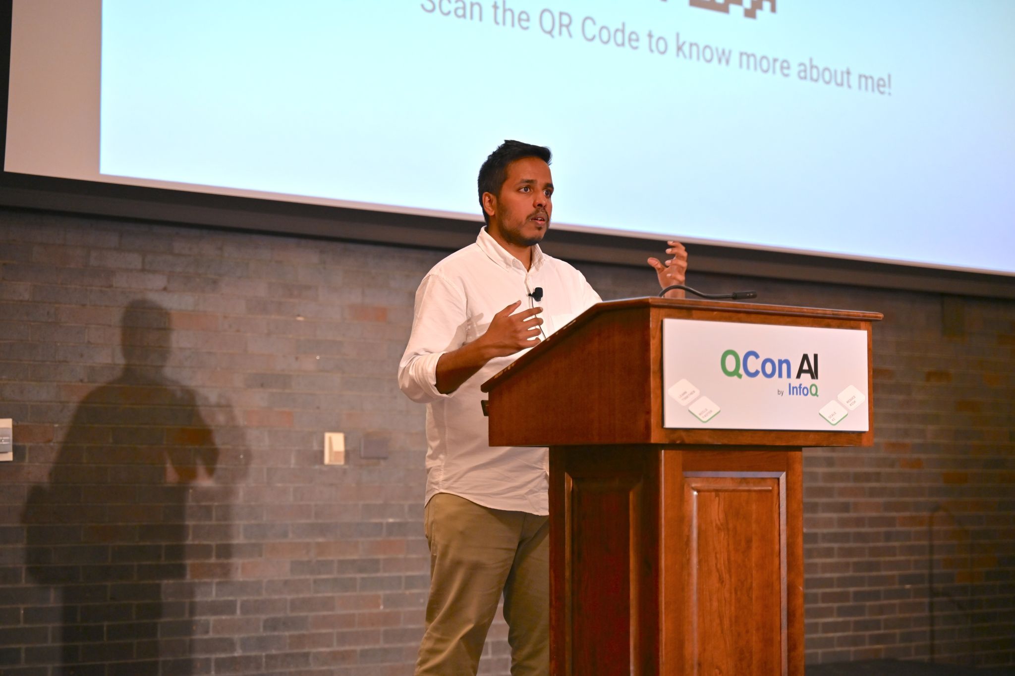 Aditya Mulik speaking at QCon AI